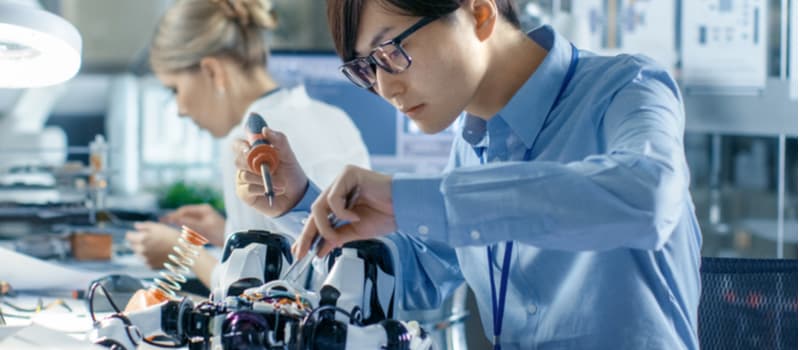 Two engineers work in a lab.