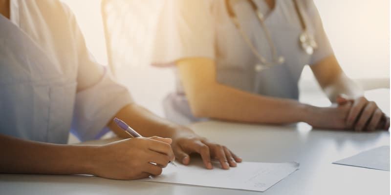 Two nurses studying at a table.