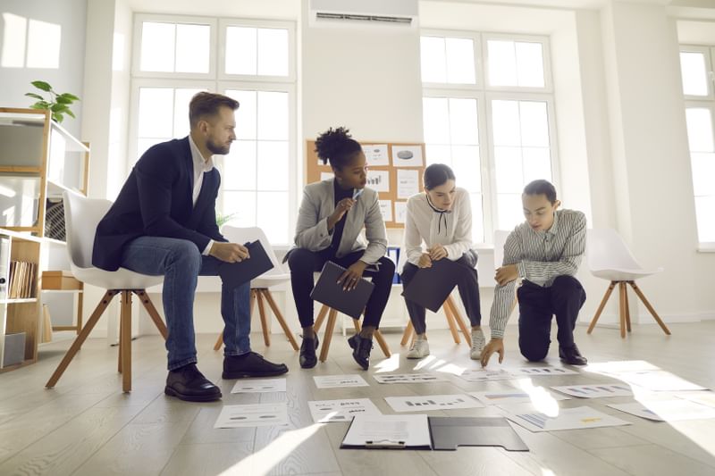 Multicultural team members work on collaborative project management