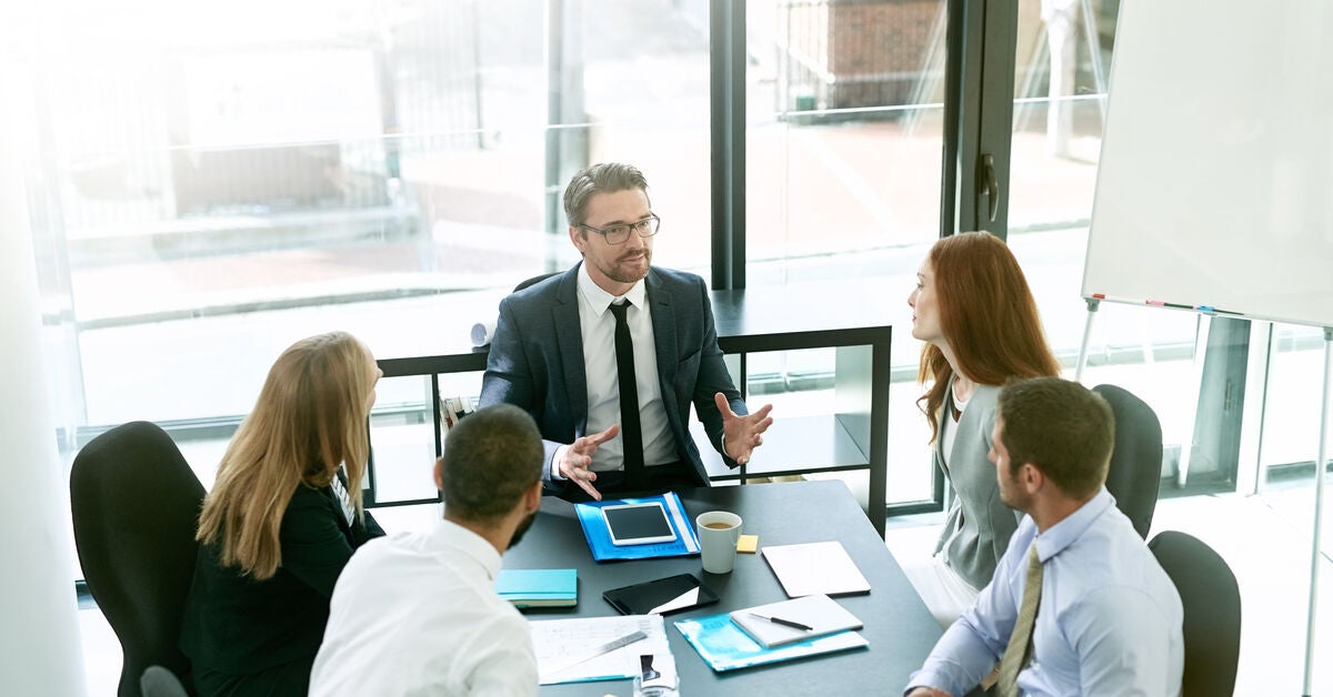 A team of executives having a formal meeting in a boardroom