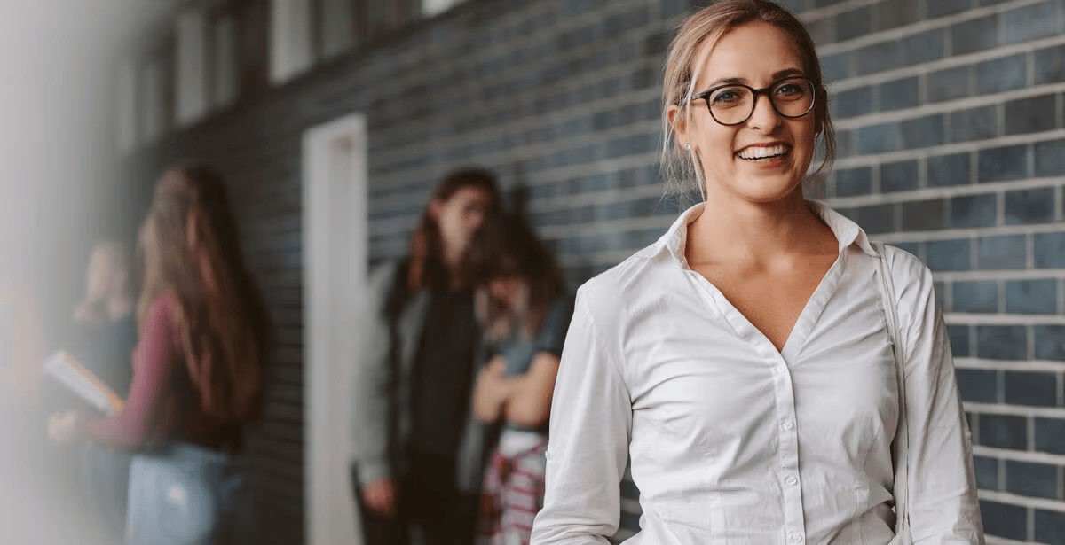 Blonde woman standing outside at school