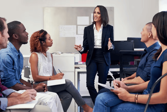 Project manager instructing a group of employees