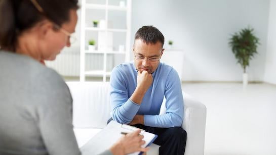 Mental health professional speaking with a man