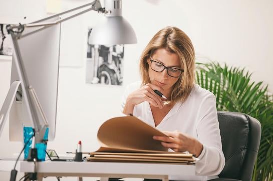 Law student at a desk studying a file