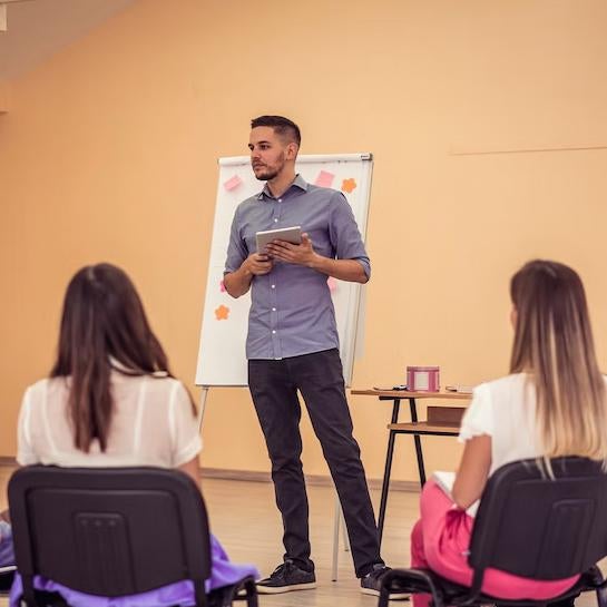 Education professional speaking in front of a crowd