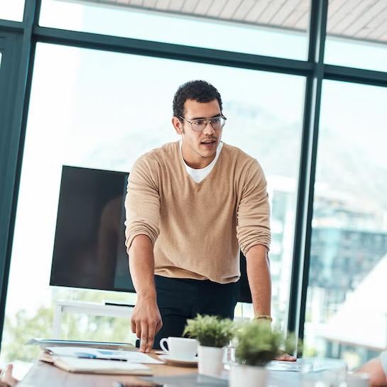 Education professional speaking in a modern boardroom