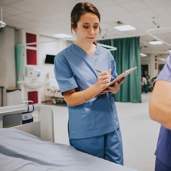 Female health professional student in scrubs working at a hospital