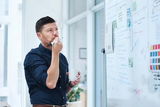 Engineer looking intently at a board