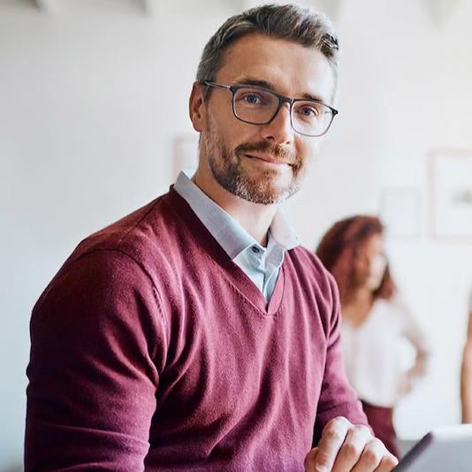 A project management professional using a laptop