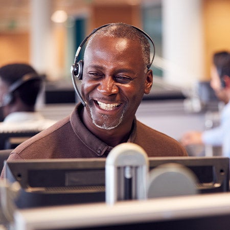 A mental health student smiling to a male teenager in an office