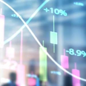 Business professionals analyzing a stock chart, discussing trends and strategies for investment decisions.