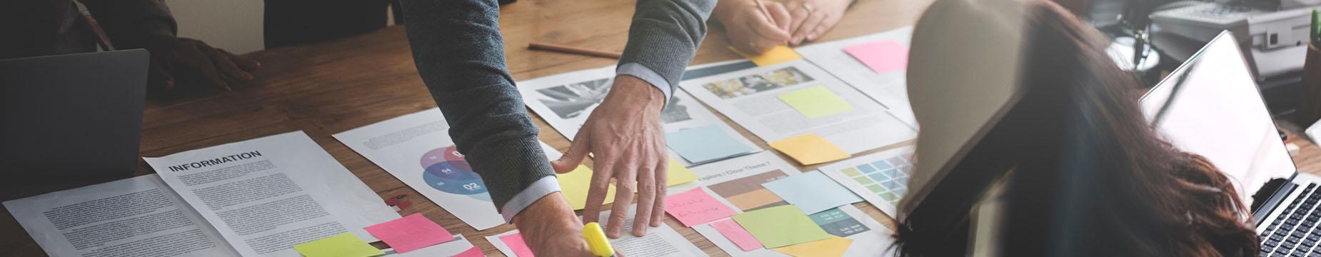 A man and woman collaborating on a project, focused and engaged in their work together.