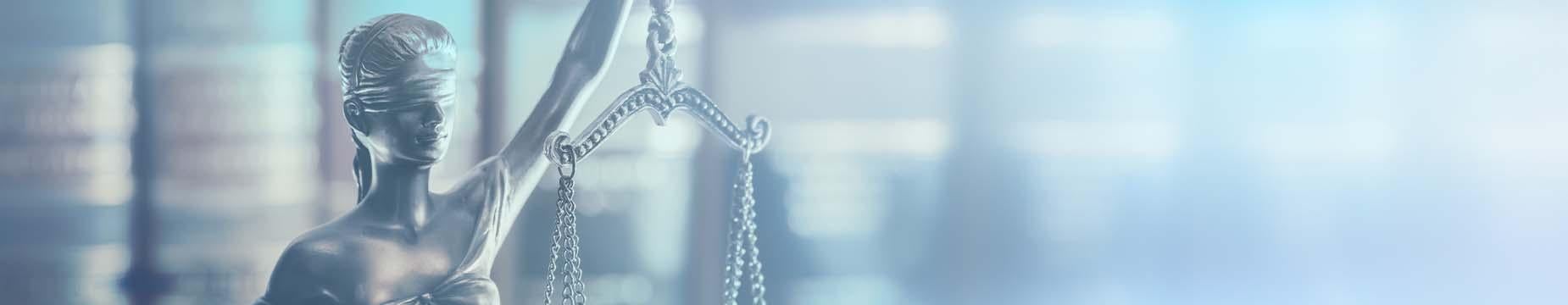 A statue of Lady Justice, elegantly poised, holding a balanced scale, symbolising fairness and impartiality in law.