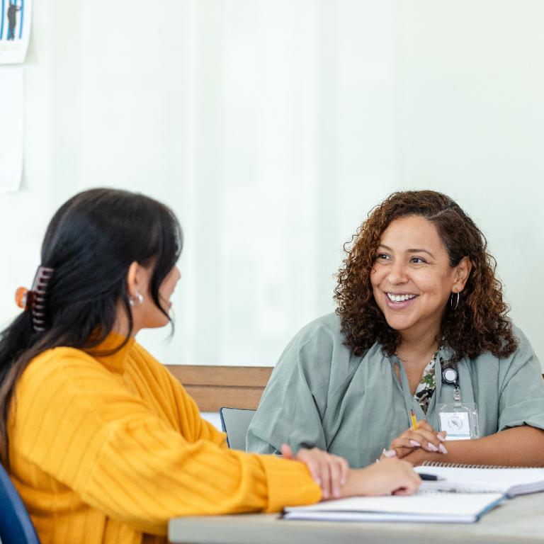 Two female friends discussing post graduate studies