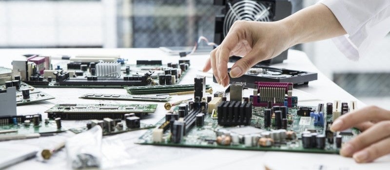 A mechanical engineer fixing a complex piece of machinery. 