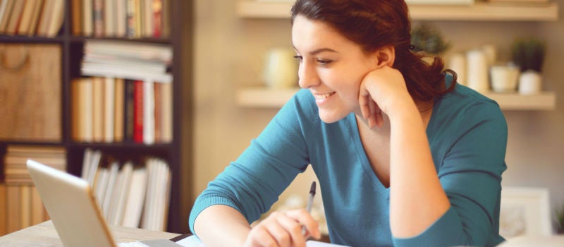 A woman enjoying her online study session. 